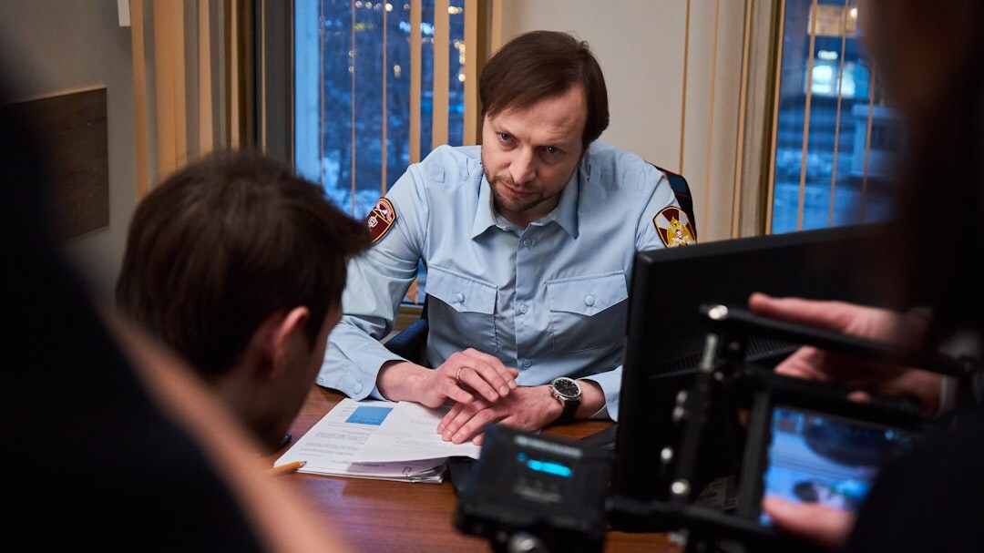 Person writing a broadcast script at a desk